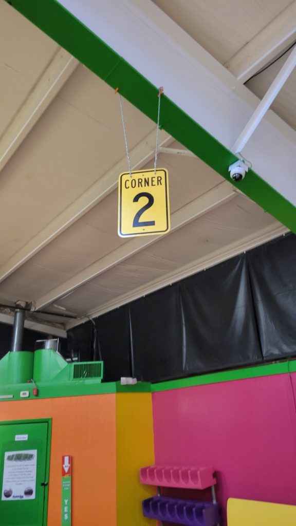 Interior of roller rink with windows closer to the ceiling that are covered in black vinyl.