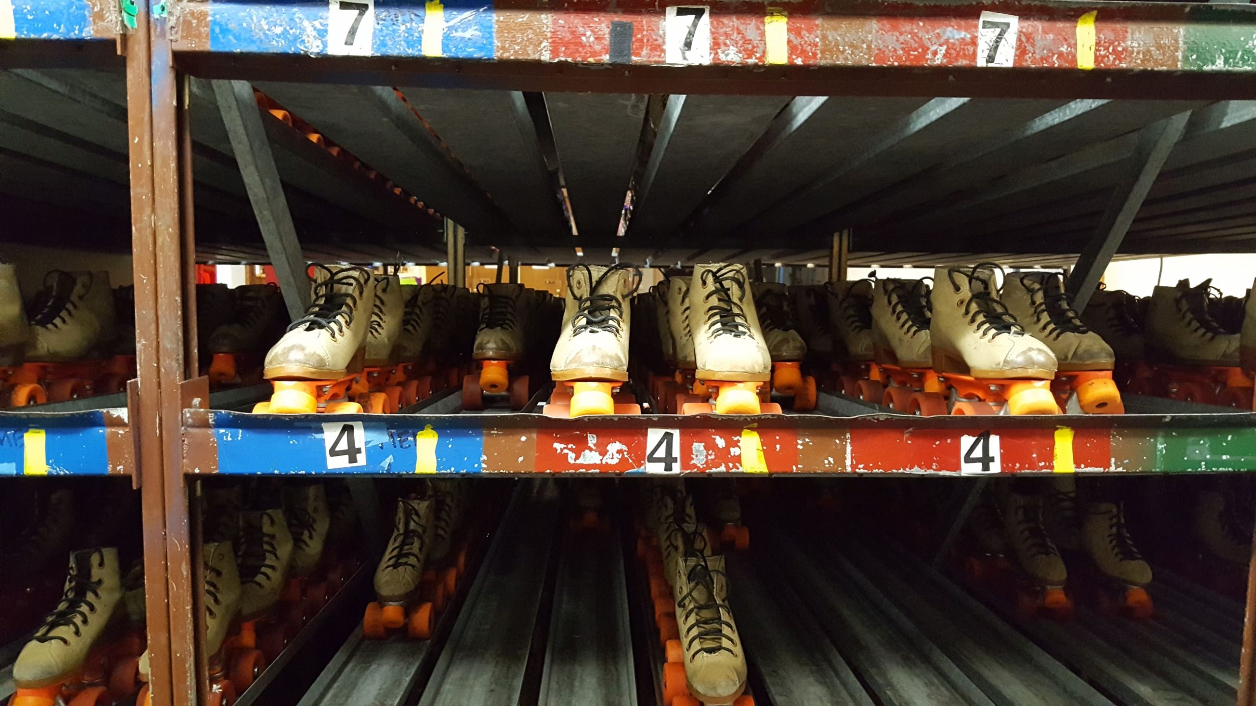 Rental skates in a gravity storage rack