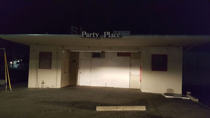 Shuttered roller rink with Party Place sign.