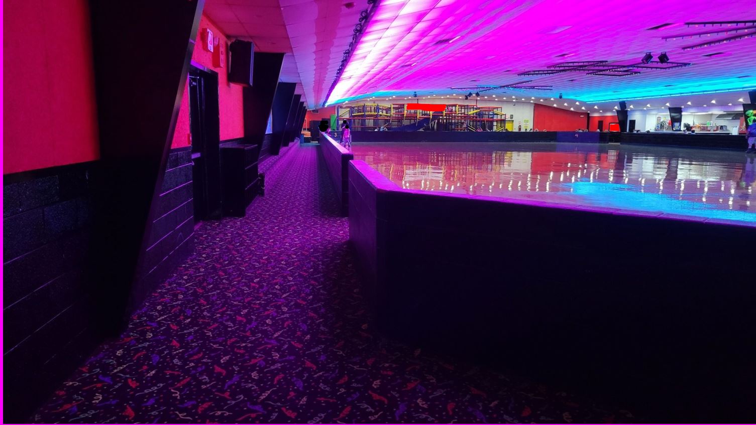 Indoor roller rink with a pink ceiling